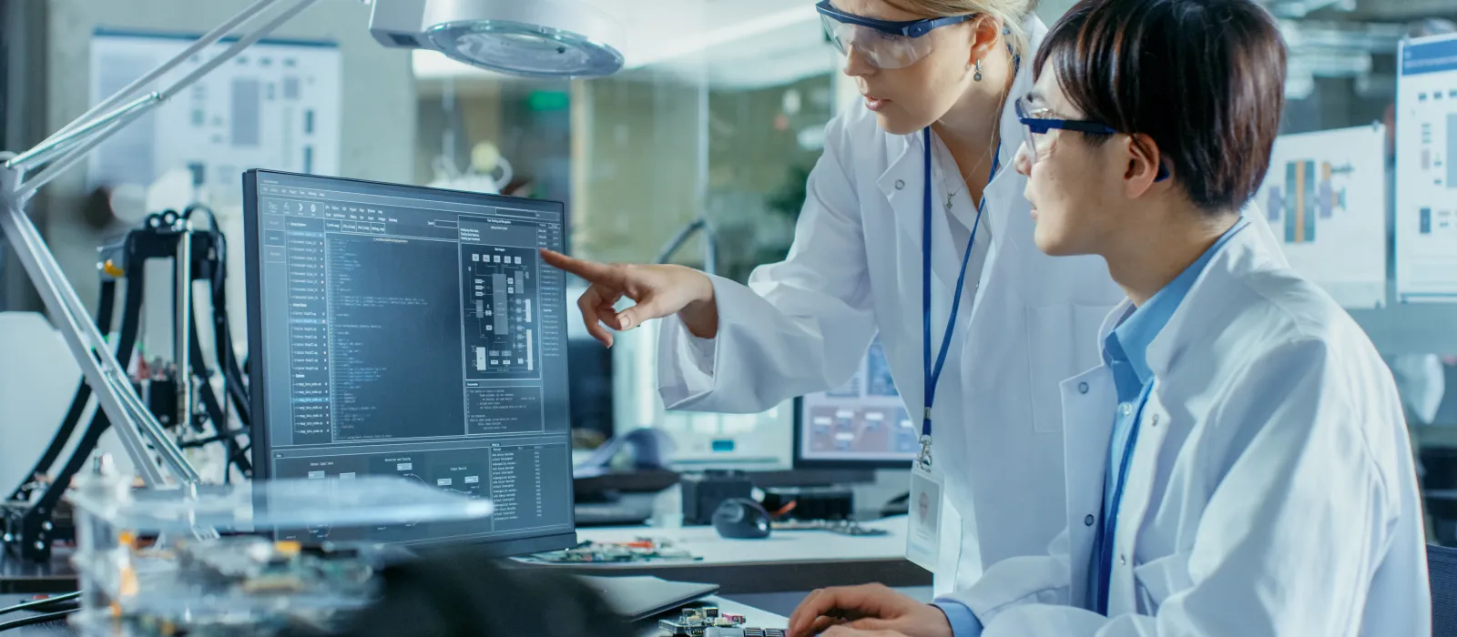 2 employees at the computer in a laboratory environment