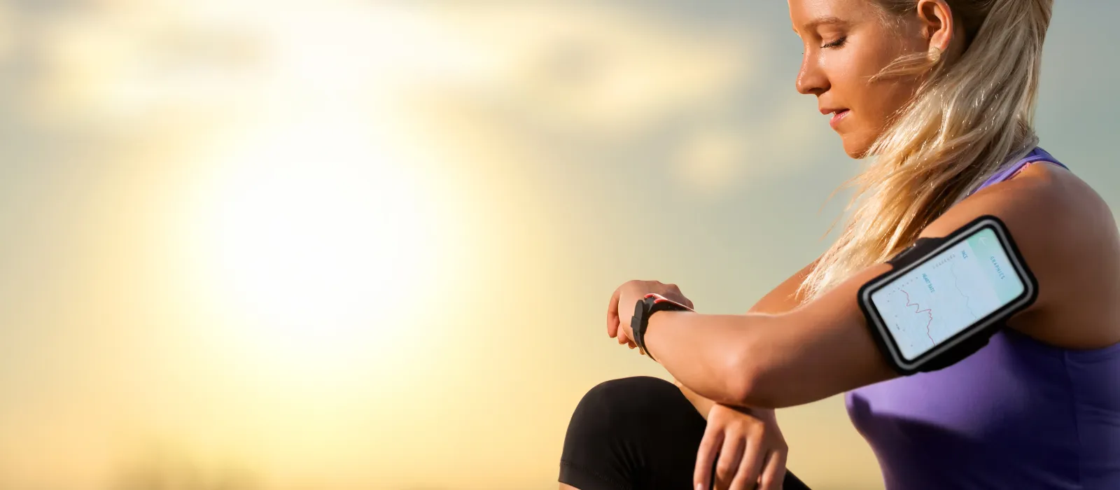 Woman checks her Bluetooth devices after the run